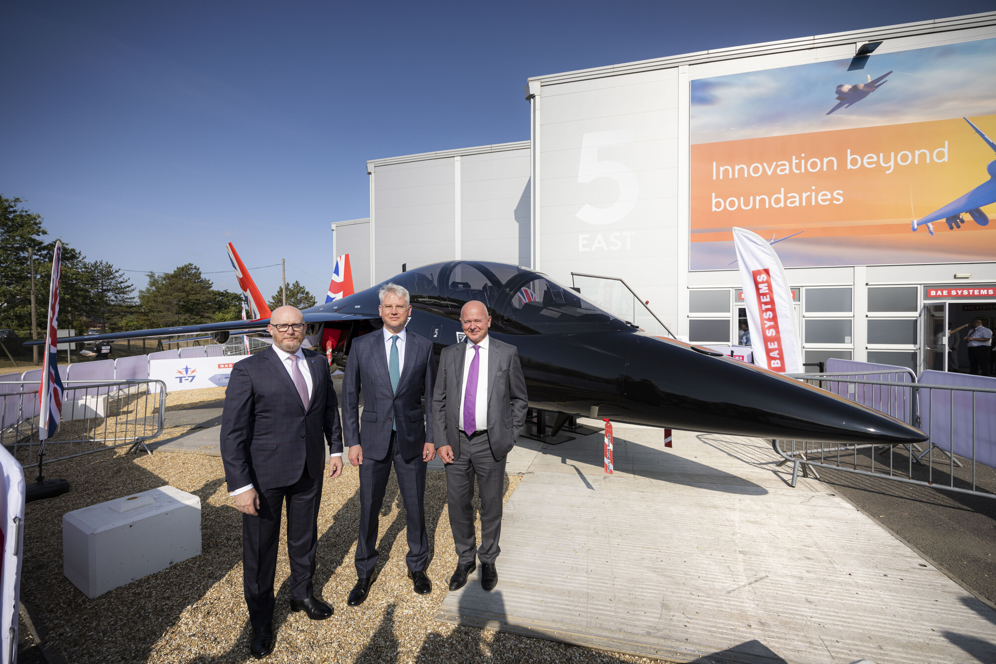 (L-R) Boeing Defense, Space & Security President and CEO Steve Parker, BAE Systems Chief Executive Charles Woodburn, and Saab President and CEO Micael Johansson stand together at the Farnborough Airshow beside BAE Systems’ full-scale replica of the Boeing T-7. The three companies have formalised a teaming agreement to develop a next-generation pilot training system for the UK. (© BAE)