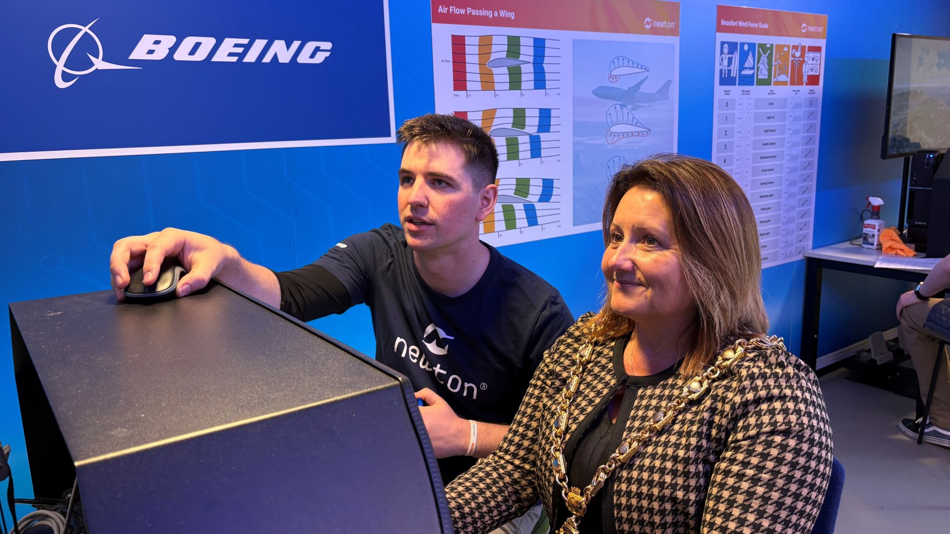Mayor of Gosport, Councillor Kirsten Bradley receives flight instruction in the Newton classroom from Boeing volunteer Jack Brinicombe.