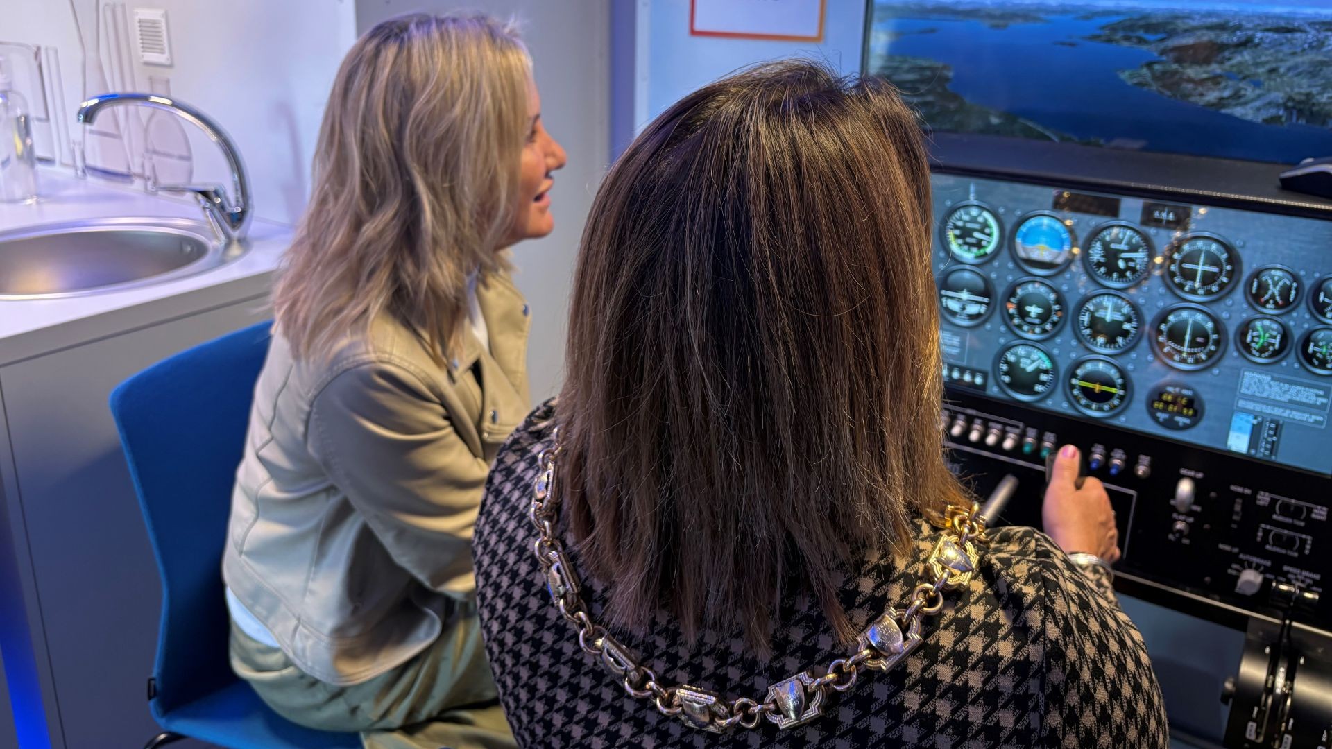 Conservative MP for Gosport, Dame Caroline Dinenage DBE MP and Mayor of Gosport, Councillor Kirsten Bradley take control of a Newton Flight Simulator